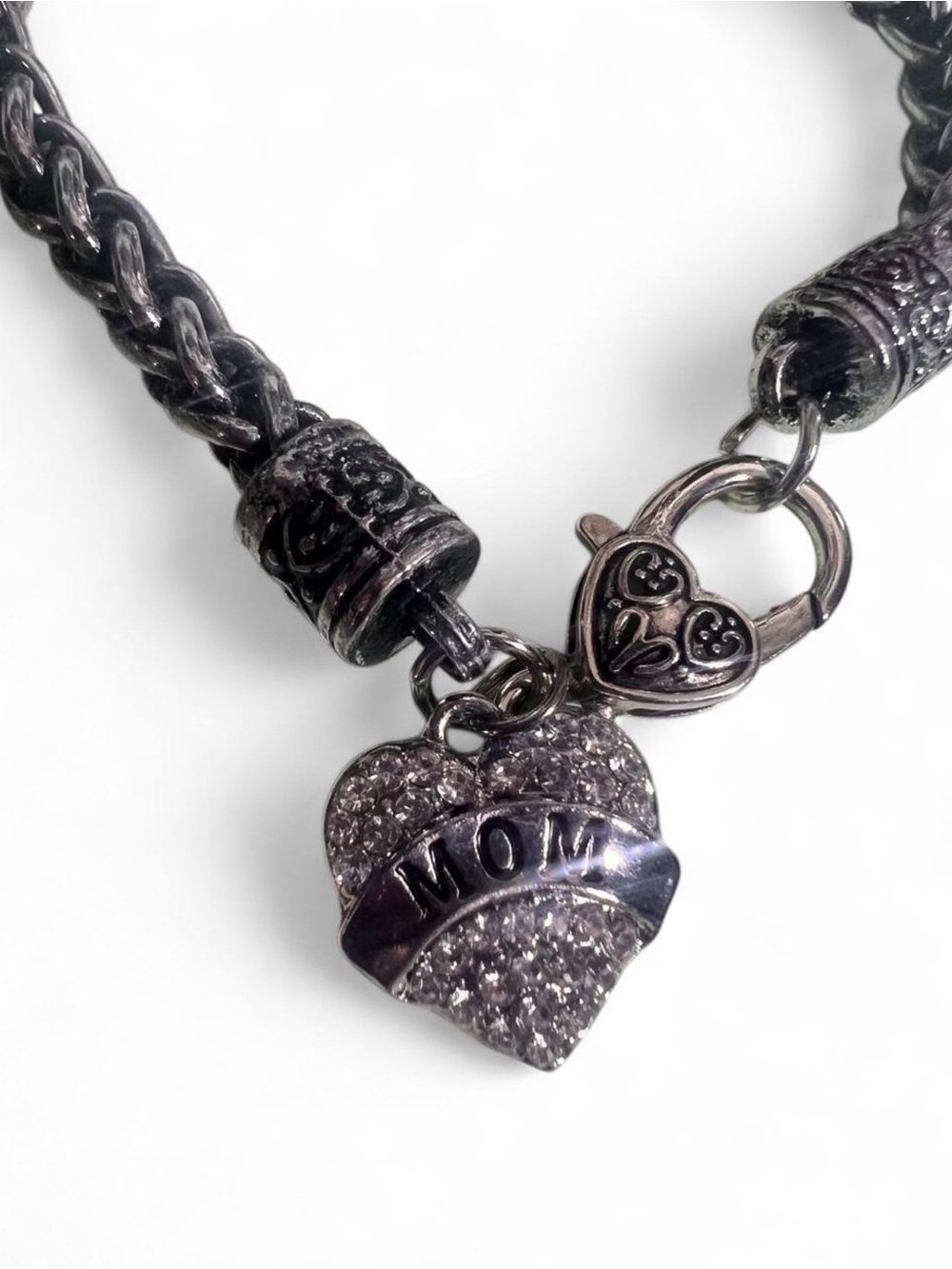 Silver heart charm bracelet with 'MOM' inscriptions.
